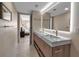 Stylish bathroom featuring a double vanity with modern fixtures and a glimpse into the cozy bedroom at 5757 Gulf Of Mexico Dr # 110, Longboat Key, FL 34228