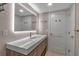 Modern bathroom vanity with quartz countertop and stylish wood cabinets, complemented by a sleek, illuminated mirror at 5757 Gulf Of Mexico Dr # 110, Longboat Key, FL 34228