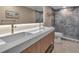 Modern bathroom featuring a double vanity with quartz countertop, contemporary fixtures, and a tiled shower at 5757 Gulf Of Mexico Dr # 110, Longboat Key, FL 34228