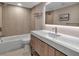 Updated bathroom featuring a tub with tile surround, modern vanity with quartz countertop, and sleek fixtures at 5757 Gulf Of Mexico Dr # 110, Longboat Key, FL 34228