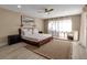 Cozy bedroom with a large window, light-colored walls, and a ceiling fan for added comfort at 5757 Gulf Of Mexico Dr # 110, Longboat Key, FL 34228
