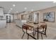 Open-concept dining room with modern table and chairs, seamlessly connected to the kitchen for easy entertaining at 5757 Gulf Of Mexico Dr # 110, Longboat Key, FL 34228