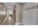 Well-lit hallway showcasing a modern design, featuring neutral wall colors, recessed lighting, and stylish wall accents at 5757 Gulf Of Mexico Dr # 110, Longboat Key, FL 34228
