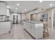 Bright, open kitchen with a large center island, seating, and updated appliances at 5757 Gulf Of Mexico Dr # 110, Longboat Key, FL 34228