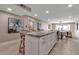 Kitchen with island and stool seating overlooks an open living space at 5757 Gulf Of Mexico Dr # 110, Longboat Key, FL 34228