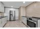Modern kitchen features stainless steel appliances, white cabinets, and sleek countertops at 5757 Gulf Of Mexico Dr # 110, Longboat Key, FL 34228