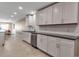 Elegant kitchen featuring white cabinets, stainless appliances, and views into the living room at 5757 Gulf Of Mexico Dr # 110, Longboat Key, FL 34228