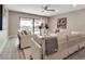 Bright and airy living room featuring neutral tones, modern furnishings, and sliding glass doors to the outdoor area at 5757 Gulf Of Mexico Dr # 110, Longboat Key, FL 34228
