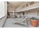 Relaxing outdoor patio features lounge chairs and dining area with bright white paint scheme at 5757 Gulf Of Mexico Dr # 110, Longboat Key, FL 34228
