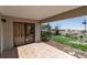 Outdoor patio with tile flooring offers partial views of the beach and lush landscaping at 5757 Gulf Of Mexico Dr # 110, Longboat Key, FL 34228