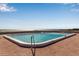 Large in-ground community swimming pool, set against a serene ocean backdrop with clear blue skies at 5757 Gulf Of Mexico Dr # 110, Longboat Key, FL 34228