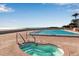 Resort style pool featuring a hot tub with partial ocean views at 5757 Gulf Of Mexico Dr # 110, Longboat Key, FL 34228