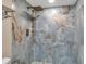 Elegant tiled shower with rainfall showerhead and stylish fixtures, creating a spa-like experience at 5757 Gulf Of Mexico Dr # 110, Longboat Key, FL 34228
