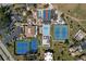 Aerial view of community pool, tennis courts, parking and buildings at 618 Bird Bay S Dr # 118, Venice, FL 34285