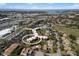 Aerial view of a condo community with mature trees and ocean views, close to parking and outdoor amenities at 618 Bird Bay S Dr # 118, Venice, FL 34285