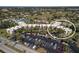A condo complex features parking and outdoor amenities like a pool and tennis court nestled among mature landscaping at 618 Bird Bay S Dr # 118, Venice, FL 34285