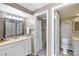 Neat bathroom with dual vanities, good lighting, and organized storage space at 618 Bird Bay S Dr # 118, Venice, FL 34285