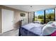 Comfortable bedroom featuring a serene view, complemented by a stylish dresser and wall-mounted TV at 618 Bird Bay S Dr # 118, Venice, FL 34285