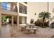 Charming courtyard with stone table and benches surrounded by lush tropical plants and mature palm trees at 618 Bird Bay S Dr # 118, Venice, FL 34285