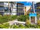 Exterior of Sandpiper condo unit showing building number, landscaping, seating and screened balconies at 618 Bird Bay S Dr # 118, Venice, FL 34285