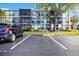 Exterior of condo building shows screened balconies, manicured grounds, and convenient parking at 618 Bird Bay S Dr # 118, Venice, FL 34285
