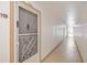 Hallway leading to unit 118 with decorative security door and bright interior, showing unit number at 618 Bird Bay S Dr # 118, Venice, FL 34285