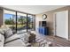 Living room features a couch, TV, screened lanai with outdoor furniture, and modern decor at 618 Bird Bay S Dr # 118, Venice, FL 34285