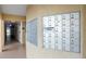 Hallway view of a bank of community mailboxes on a textured wall with adjacent doors at 618 Bird Bay S Dr # 118, Venice, FL 34285