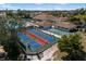 Aerial view of vibrant pickleball courts with players and community facilities with lush greenery at 618 Bird Bay S Dr # 118, Venice, FL 34285