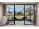Screened lanai with outdoor seating provides serene views of lush greenery and allows for outdoor relaxation at 618 Bird Bay S Dr # 118, Venice, FL 34285