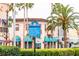 Community directional signage for the beach, theater, cultural campus, and fishing pier amidst lush landscaping at 618 Bird Bay S Dr # 118, Venice, FL 34285