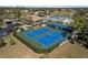 Aerial view of well-maintained tennis courts in a beautiful community setting, perfect for active residents at 618 Bird Bay S Dr # 118, Venice, FL 34285