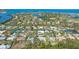 Aerial view of property in coastal community with canal access and proximity to a golf course at 618 Buttonwood Dr, Longboat Key, FL 34228