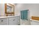 Bathroom with a quartz countertop, shaker cabinets, and wood trim mirror at 618 Buttonwood Dr, Longboat Key, FL 34228