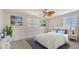 Inviting bedroom with natural light, featuring a decorative ceiling fan and charming nautical art at 618 Buttonwood Dr, Longboat Key, FL 34228