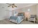 Cozy bedroom with a ceiling fan, wood-look floors, and closet space at 618 Buttonwood Dr, Longboat Key, FL 34228