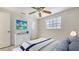 Cozy bedroom featuring coastal decor, a ceiling fan, and a bright window at 618 Buttonwood Dr, Longboat Key, FL 34228