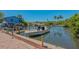 Boat docked at a private residential pier along a canal on a sunny day at 618 Buttonwood Dr, Longboat Key, FL 34228