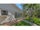Exterior view of home with white shutters, flower box and a brick path leading through a verdant yard at 618 Buttonwood Dr, Longboat Key, FL 34228