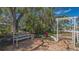 Garden with white bench, an arbor, lush plants, and brick patio flooring at 618 Buttonwood Dr, Longboat Key, FL 34228
