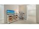Bright home office features custom shelving and storage near an open doorway to a large flexible space at 618 Buttonwood Dr, Longboat Key, FL 34228