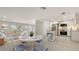 Charming kitchen with stainless steel appliances and an island, open to the living and dining areas at 618 Buttonwood Dr, Longboat Key, FL 34228