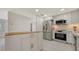 Modern kitchen with stainless steel appliances and white cabinets, designed for both style and functionality at 618 Buttonwood Dr, Longboat Key, FL 34228