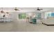 Spacious living area with multiple ceiling fans and sliding glass doors, seamlessly blending indoor-outdoor living at 618 Buttonwood Dr, Longboat Key, FL 34228