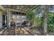 Enclosed patio with ceiling fan, brick flooring, and view of garden through clear glass panels at 618 Buttonwood Dr, Longboat Key, FL 34228