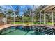Screened in pool reflects surrounding landscaping in this relaxing outdoor living area at 618 Buttonwood Dr, Longboat Key, FL 34228