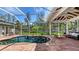 Wide view of pool within screened lanai with brick patio, outdoor seating, and ceiling fan at 618 Buttonwood Dr, Longboat Key, FL 34228