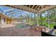 Comfortable seating near a private in ground pool in a screened in lanai with brick paver deck at 618 Buttonwood Dr, Longboat Key, FL 34228