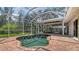 Relaxing private screened-in pool area, outdoor seating with ceiling fans, and surrounding landscaping at 618 Buttonwood Dr, Longboat Key, FL 34228