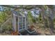 Charming shed nestled under a large oak tree with lush tropical landscaping at 618 Buttonwood Dr, Longboat Key, FL 34228